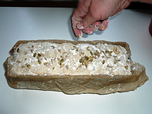 Sprinkel seeds etc on the dough